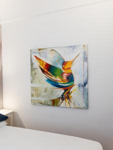 a painting of a bird hanging on a wall at Casa Misette 200mq a due passi dal mare in Alassio