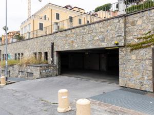 a stone building with a large parking garage at Casa Misette 200mq a due passi dal mare in Alassio