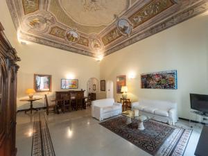 a living room with a coffered ceiling and white furniture at Casa Misette 200mq a due passi dal mare in Alassio
