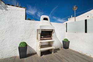 a white building with a staircase in the side of it at Sunset House Maspalomas in Playa del Ingles