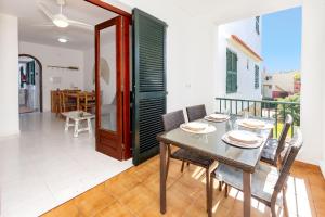 a dining room with a table and chairs at Biniforcat in Cala en Forcat
