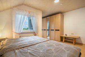 a bedroom with a large bed with a window at Ferienwohnung Viola in Schwanau in Schwanau