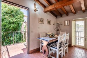 comedor con mesa y sillas y balcón en Appartamento La Terrazza, en Porcari