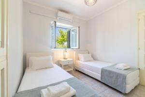 Postel nebo postele na pokoji v ubytování Antipaxos sunset house + 24 fotografií