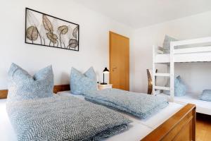 a bedroom with two bunk beds with blue pillows at Ferienwohnung Zola in Ettenheim
