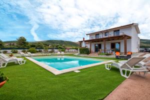 a villa with a swimming pool and a house at Villa Felicità in Sorso