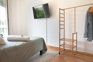 a room with a ladder next to a bed and a tv at Marzamemi Porto in Marzamemi