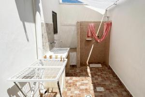 a bathroom with a sink and a shower at Vento Di Mare in Torre Lapillo +14 photos