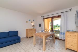 sala de estar con sofá azul y mesa en I Mirti, en Porto Pozzo