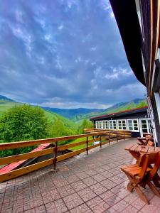 a balcony of a building with a view of the mountains at Hotel Pod Sokolím in Terchová