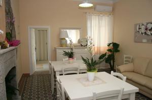 a living room with two tables and a couch at Guest House Le Gemelle in Luras