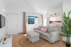 a living room with a couch and a table at Bungalow Alma Ocean View in Puerto del Carmen