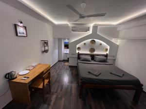 a small room with a bed and a table at The French Villa Elite in Puducherry