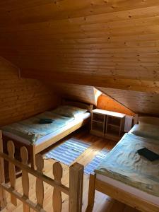 an attic with two beds and a stove in it at Hotel Pod Sokolím in Terchová