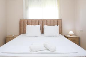 Ένα ή περισσότερα κρεβάτια σε δωμάτιο στο Anemone Apartment
