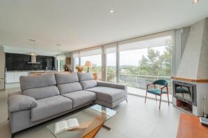 a living room with a couch and a fireplace at Casa Majestic in Cunit