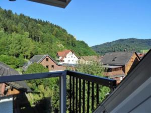a balcony with a view of a town and mountains at Ferienwohnung Burgblick in Hausach