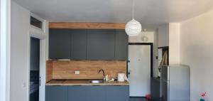 a kitchen with a sink and a refrigerator at Kevin&Elisa Your home! in Lezhë