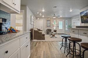 a kitchen with bar stools and a living room at Summer Fun 5br Family Haven - Hot Tub 5000 in Bethany