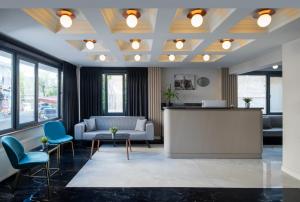 an office lobby with a reception desk and blue chairs at İstanbul Efes Hotel in Istanbul