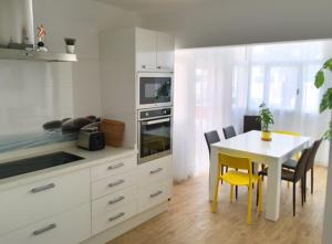 a kitchen with a table and a table and chairs at Corralejo beach life in La Oliva