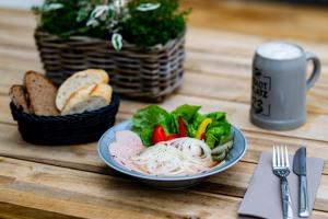 a plate of food with noodles and vegetables on a table at Stadtplatz23 B&B in Bogen +13 photos