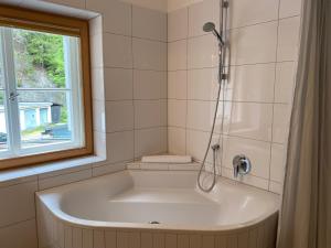 a white bath tub in a bathroom with a window at Gasthof Kronburg in Zams