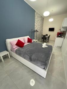 una camera da letto con un grande letto con cuscini rosa di Margò Luxury a Mola di Bari