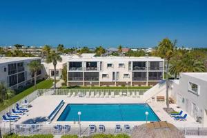 an aerial view of a large building with a swimming pool at Oceanfront retreat, serene views & screened lanai #30 in Marathon