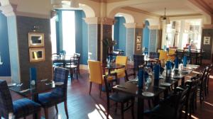 a dining room filled with tables and chairs at The Lodge on the Loch by OYO in Onich +96 photos