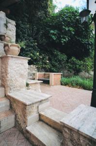 a set of stairs and a bench in a courtyard at Villa Pietrantoni in Tivoli