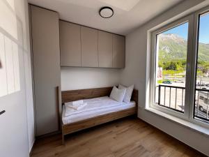 a small room with a bed and a window at Alpine Haven in Bovec