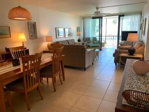 a living room with a couch and a table and chairs at Outstanding Oceanfront Oasis Directly on Beach #8 in Marathon