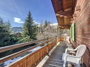 a deck with two white chairs on a house at Pâquerette 1er in Verbier