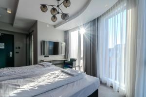 Ένα ή περισσότερα κρεβάτια σε δωμάτιο στο Midtown Hotel