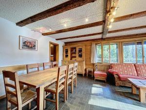 a dining room with a wooden table and chairs at Pâquerette 1er in Verbier