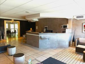 eine Lobby mit einer Bar und einem Essbereich in der Unterkunft Cit'Hotel Hotel Prime - A709 in Saint-Jean-de-Védas