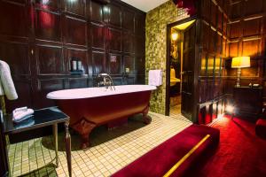 a large bathroom with a large tub in it at Lumley Castle Hotel in Chester-le-Street
