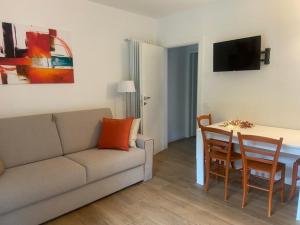 a living room with a couch and a table at CASA VACANZE LA BRENTA in Chiavenna