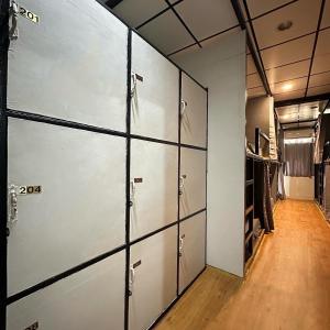 a row of lockers in a room with a hallway at Bed Space Hostel @Khaosan in Bangkok