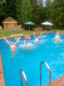 a group of people in a swimming pool at Olza Karczma i pokoje in Istebna
