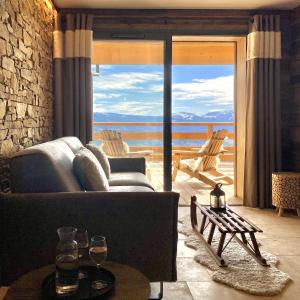 a living room with a couch and a view of the ocean at Résidence l'Insolite in Font Romeu Odeillo Via