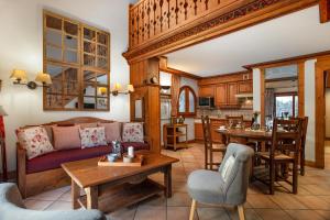 a living room with a couch and a table at Résidence Le Cristal-Mont Blanc 18 - Happy Rentals in Argentiere