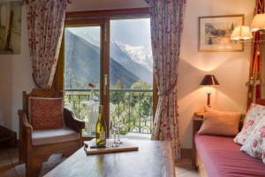 a living room with a window with a view of a mountain at Résidence Le Cristal-Mont Blanc 18 - Happy Rentals in Argentiere
