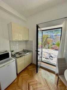 a kitchen with a door open to a patio at Apartments Marina in Budva