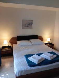 Un dormitorio con una cama grande con toallas. en MirkasHouse, en Limenas 9 fotos más