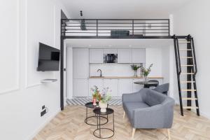 a living room with a couch and a loft bed at Apartment with Balcony - Starowiślna 41 in Kraków