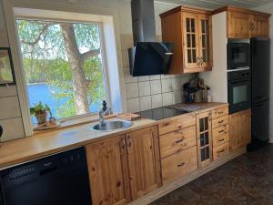 uma cozinha com um lavatório e uma grande janela em Kaffestugan em Hällefors
