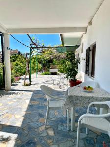 a stone patio with a table and chairs at Apartments Marina in Budva