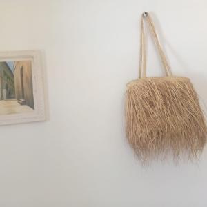 a basket hanging on a wall next to a picture at Usumba Lodge 